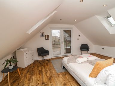 A bedroom with a bed and furniture at Lodge 24 South Hykeham