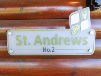 A sign with St Andrews No 2 mounted on a wooden surface