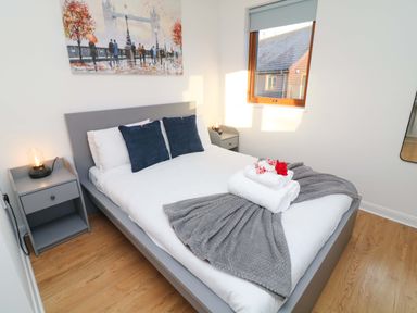 A bedroom with a bed and bedside table at Lodge 2 in South Hykeham