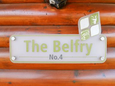 A wooden wall with a sign that says The Belfry No 4