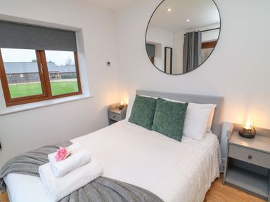 A bedroom with a bed and bedside tables at Lodge 7 in South Hykeham