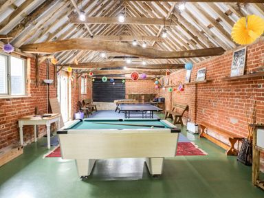 A game room with a pool table a ping pong table and foosball tables at The Brambles in Polstead