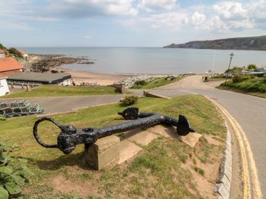 An anchor on a hillside overlooking the sea at Primrose Lodge in Runswick Bay near Staithes