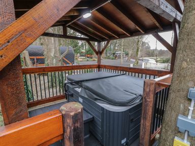 An outdoor covered wooden structure with a hot tub inside at Pine in Dungiven Londonderry