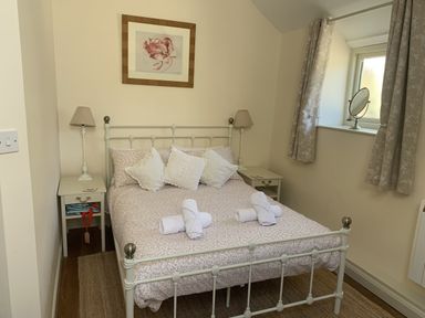 A bedroom with a double bed and bedside tables at The Calf Pen in Colyton