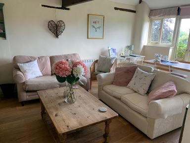A living room with a couch and coffee table at The Bull Pen in Colyton