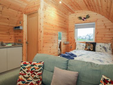 A bedroom with a bed and kitchenette at Holly in Ulverston