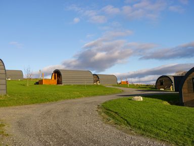 An outdoor area with glamping pods and a pathway at Holly in Ulverston