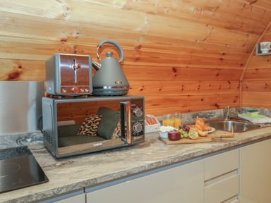 A kitchen with a microwave, kettle, and toaster at Willow in Ulverston