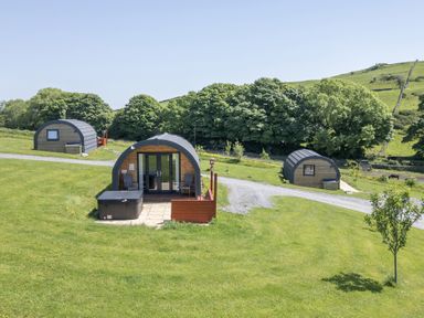 Three cabins in a grassy area at Willow Ulverston