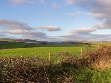 A landscape with green fields and hills at Oak in Ulverston