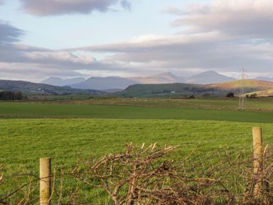 A field with mountains in the background at Oak in Ulverston