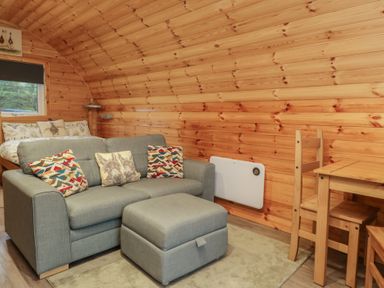 A living room with a sofa and a table at Rowan in Ulverston