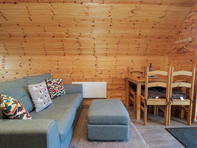 A living room with a sofa, table and chairs at Cherry in Ulverston