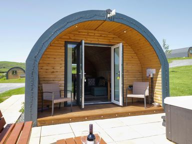 A pod with chairs and a table in an outdoor area at Cherry in Ulverston