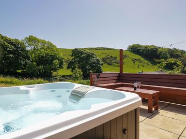 A hot tub and seating area with a view at Cherry in Ulverston