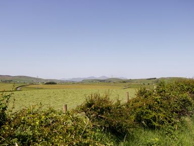 A view of fields and hills under a clear sky at Cherry in Ulverston