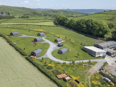 An outdoor area with cabins and fields at Cherry Ulverston
