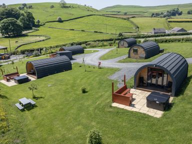 An outdoor area with cabins and hot tubs at Cherry in Ulverston