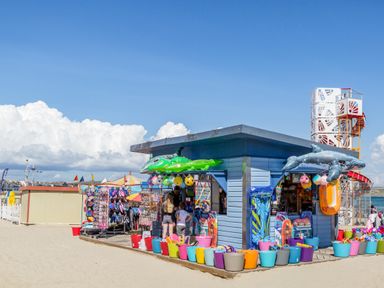 A beach shop with inflatable toys and colorful buckets on sand near the sea at Day Cottage in Weymouth