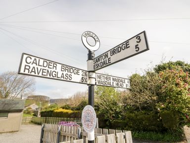 A signpost showing directions to Calder Bridge Ravenglass Santon Bridge Eskdale Nether Wasdale and Wasdale Head in Gosforth