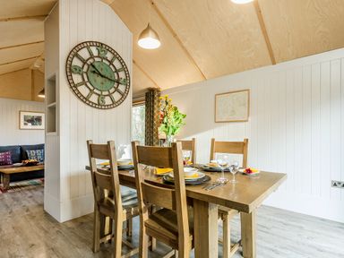 A dining room with a table and chairs at Lodge 15 in Corfe Castle