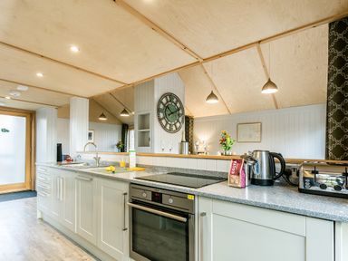 A kitchen with a sink and appliances at Lodge 16 Corfe Castle