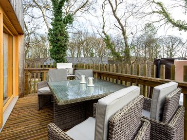 An outdoor area with a table and chairs at Lodge 16 Corfe Castle
