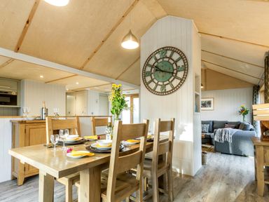 A dining room with a table and chairs at Lodge 17 Corfe Castle