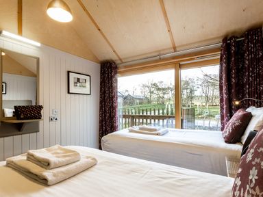 A bedroom with two beds and a view at Lodge 17 Corfe Castle