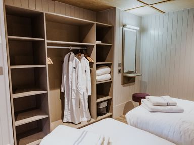 A bedroom with wardrobes and towels at Lodge 19 Corfe Castle