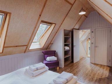 A bedroom with a bed and shelves at Lodge 19 in Corfe Castle