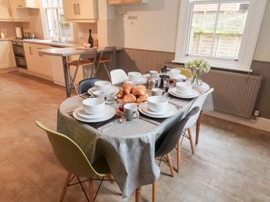 A dining room with a table set for breakfast at Elkhorn in Southwold