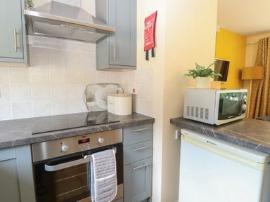 A kitchen with oven, stove, and microwave at 15 The Dell Mundesley