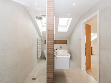 A bathroom with a shower, sink, and skylights at Bilsham Meadows in Aust