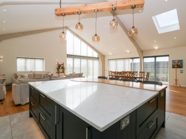 A kitchen with a large island and dining area at Bilsham Meadows in Aust