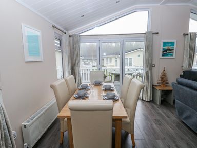 A dining room with a table and chairs at Dono's Lodge, Stepaside near Kilgetty, Heritage Park