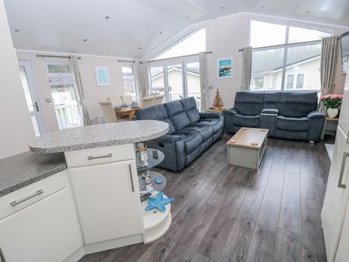A living room with a sofa and coffee table at Dono's Lodge, Stepaside near Kilgetty, Heritage Park