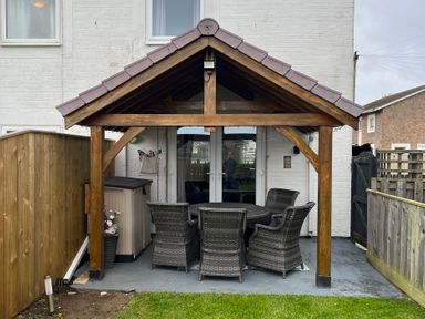 An outdoor patio with a table and chairs at 22 Longstone Park Beadnell