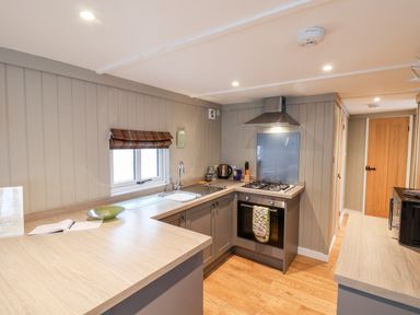 A kitchen with wooden countertops a stove microwave and sink at Grouse Lodge in Seamer North Yorkshire