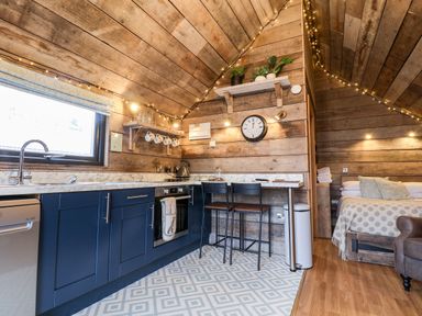A kitchen and bedroom area with wooden walls and ceiling at Sunset Retreat in Seamer North Yorkshire