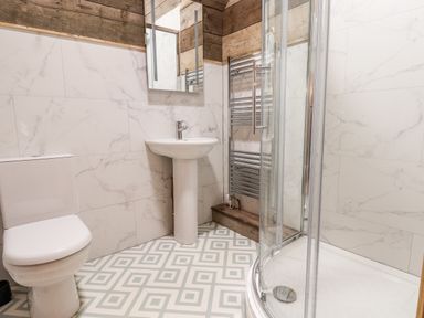 A bathroom with a toilet sink shower and towel rack at Sunset Retreat in Seamer North Yorkshire