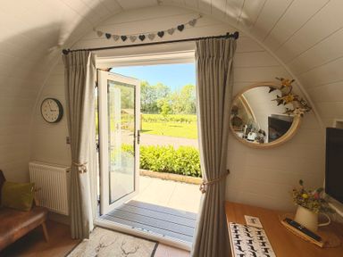 A room with a door and sofa at Oh Deer Ashbourne