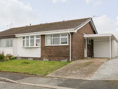 A semi detached house with a garage and driveway at 17 Ffordd Gwenllian in Llanfairpwllgwyngyll