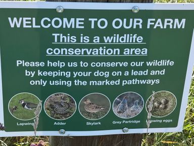 A sign for a wildlife conservation area showing various wildlife at Pond Cottage in Alnmouth