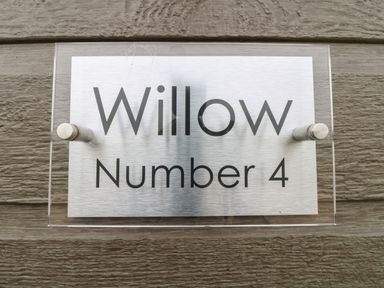 A house name sign reading Willow Number 4 mounted on a wooden wall at Willow Lodge in Winthorpe near Newark-On-Trent