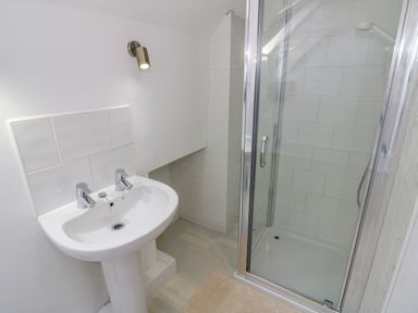 A bathroom with a pedestal sink and a glass shower enclosure at The Paddock in New Yatt near Witney