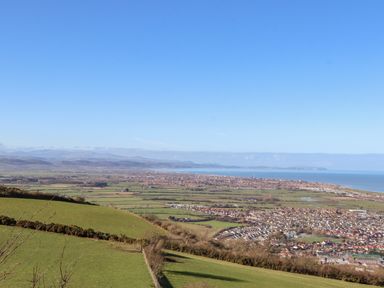 A coastal town with fields and houses overlooking the sea at Cariad Bach in Gwaenysgor near Prestatyn