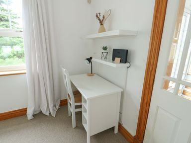 A workspace with a desk and chair at Bwthyn Clai in Llangefni