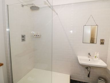 A bathroom with a walk in shower sink mirror and toiletries at Fairoaks Barns Hollybush near Ledbury